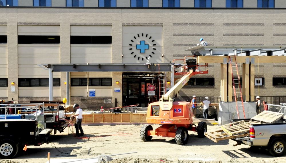 Workers renovate the new entrance at the rear of the Thayer Center for Health hospital in Waterville