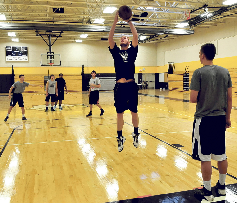 University of Maine in Farmington basketball player Nate Carson shoots during a basketball clinic held by UMF alum and coach of the Charlotte Hornets Steve Clifford on Sunday at Mt. Blue High School in Farmington.