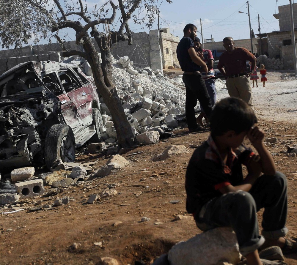 lasd;lfjlj ..... Residents inspect a damaged site in what activists say was a U.S. strike in Kfredrian, Idlib province September 23, 2014.   REUTERS/Abdalghne Karoof (SYRIA - Tags: POLITICS CIVIL UNREST CONFLICT) - RTR47EZZ