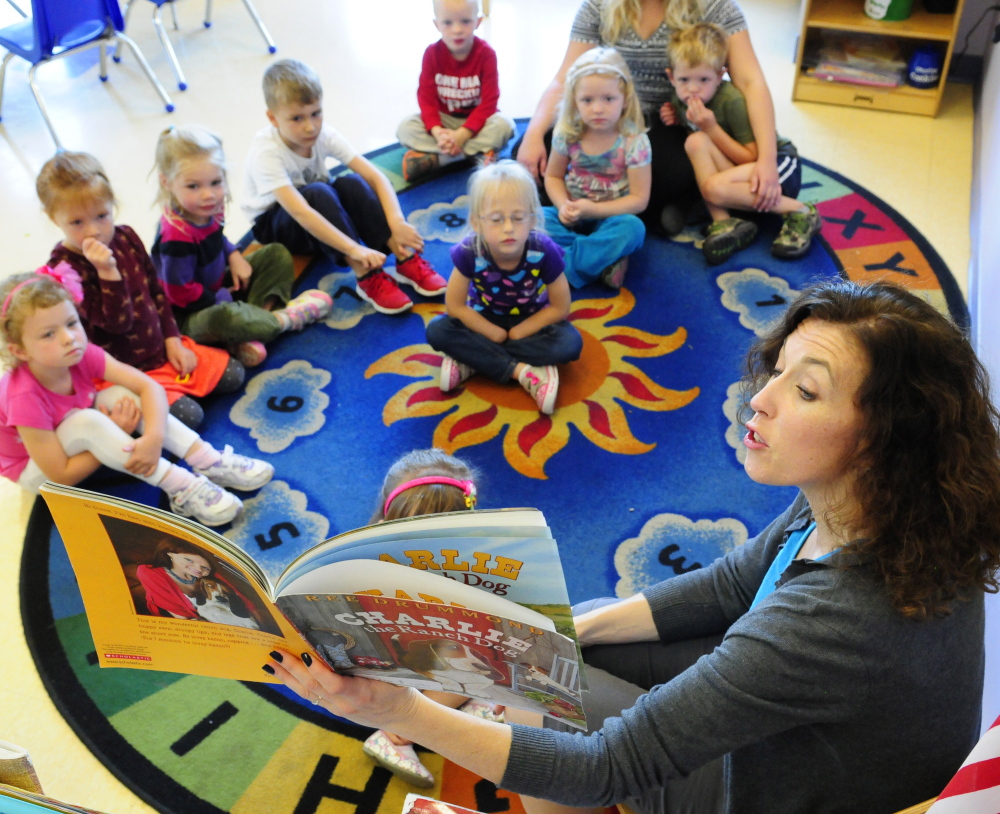 Susanne Murphy reads a book to a group of her 4-year old students on Friday in the Learning Center at the Kennebec Valley YMCA in Augusta. The YMCA and Lithgow PUblic Library are teaming up on a fundraiser that will benefit both organizations.