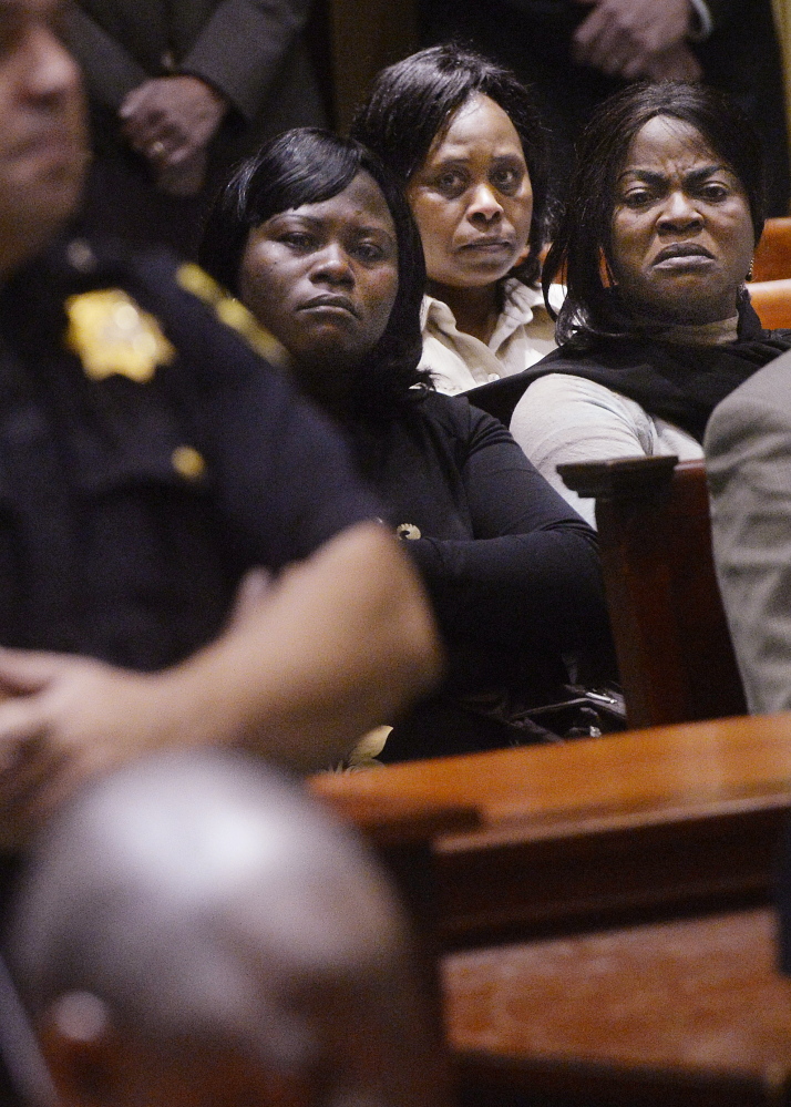 Women from the African immigrant community look towards Evaristo Deus as he arrived in court for his initial appearance in Androscoggin County Superior Court Friday. Deus was charged with the murder of Laudrinha Kubeloso and her unborn child.