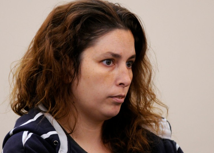 Erika Murray is arraigned at Uxbridge District Court in Uxbridge, Mass. on Friday. Murray, 31, was arrested Thursday night on charges including fetal death concealment, witness intimidation and permitting substantial injury to a child. Not guilty pleas were entered Friday on her behalf.  Detectives investigating a case of reckless endangerment of children found the bodies this week at the house littered with soiled diapers in Blackstone, about 50 miles southwest of Boston.  (AP Photo/Worcester Telegram & Gazette,  Paul Kapteyn, Pool)