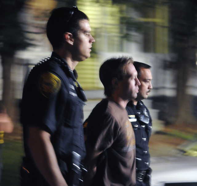 Augusta Police escort Jason Boucher to an ambulance Monday outside a Cedar Street apartment building where he barricaded himself for about an hour. Boucher was arrested and charged with a Saturday night stabbing. 