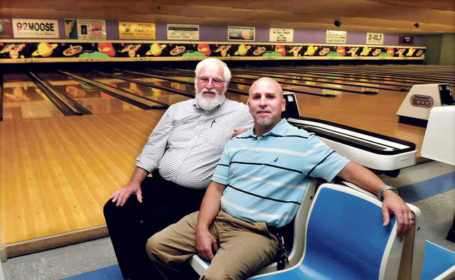 Sparetime Recreation bowling alley owner Andy Couture, left, and the Rev. Craig Riportella of Centerpoint Community Church sit at the Waterville bowling alley. The school will buy the business in January, but will keep the alley operating until April before converting the building for church needs.