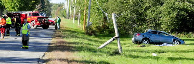 Police and firefighters investigate a car accident in which a vehicle left St. Albans Road and struck a utility pole on Monday.