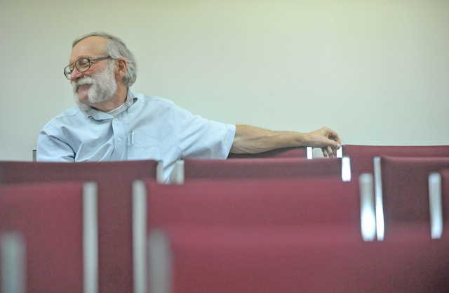 Peter Nielsen, Oakland town manager, talks with councilmen during a town meeting at the Oakland town office on Wednesday.