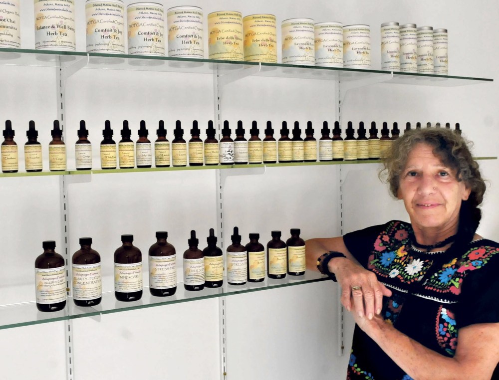 Gail Edwards displays products she makes with locally grown herbs at the Blessed Maine Herb farm in Athens. Edwards plans to participate in a meeting Sunday to select indigenous plants to plant at a new park at the base of the Skowhegan Indian statue.