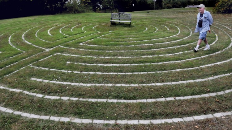 Mike Monahan walks the paths of the Labyrinth he created at his home in Farmington where people can be alone to concentrate on their thoughts. “It is  a tool to meditate,” Monahan said.
