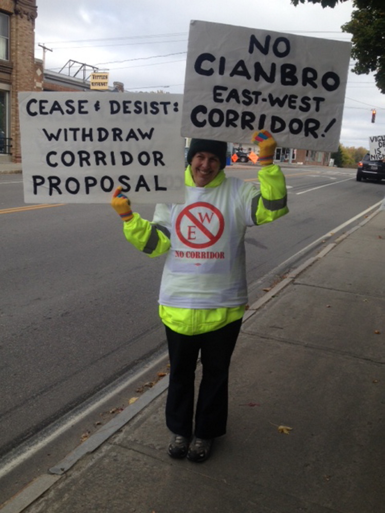 Sidney Mitchell of Dover Foxcroft demonstrates Friday outside Cianbro headquarters in Pittsfield. Mitchell is part of a group that opposes a proposed toll highway from Maine to Canada.