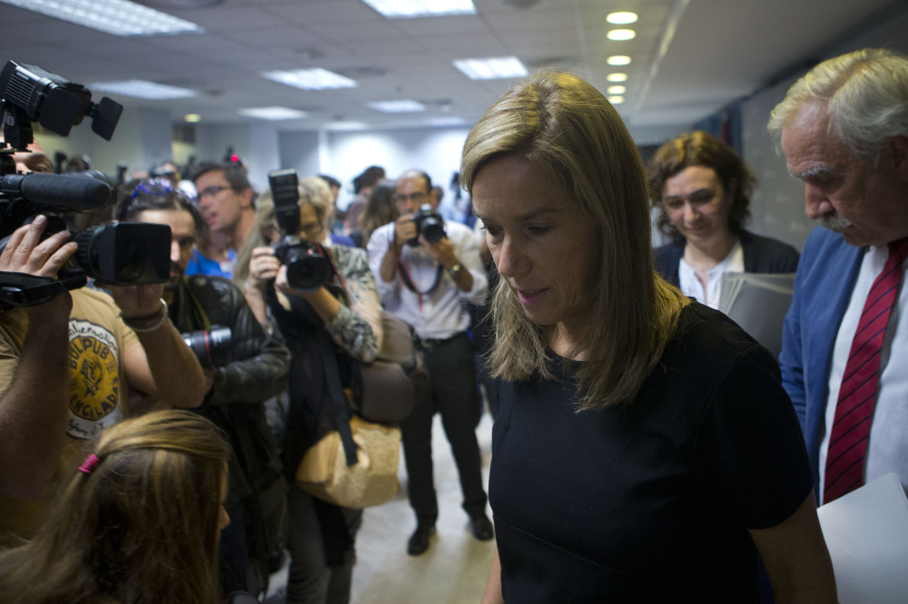 Spain’s Health Minister Ana Mato walks past members of the media as she leaves a news conference on the first reported incident of Ebola transmission outside Africa, in Madrid, Spain, Monday.