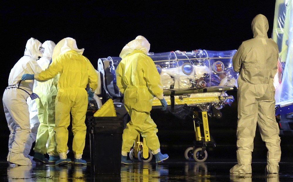 This is a Monday, Sept. 22, 2014 file photo  provided by the Spanish Defense Ministry, aid workers and doctors transfer Manuel Garcia Viejo, a Spanish priest who was diagnosed with the Ebola virus while working in Sierra Leone, from a military plane to an ambulance as he leaves the Torrejon de Ardoz military airbase, near Madrid, Spain.