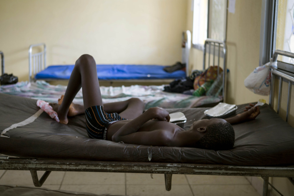 A child suffering from the Ebola virus receives treatment at Makeni Arab Holding Centre in Makeni, Sierra Leone, Saturday.