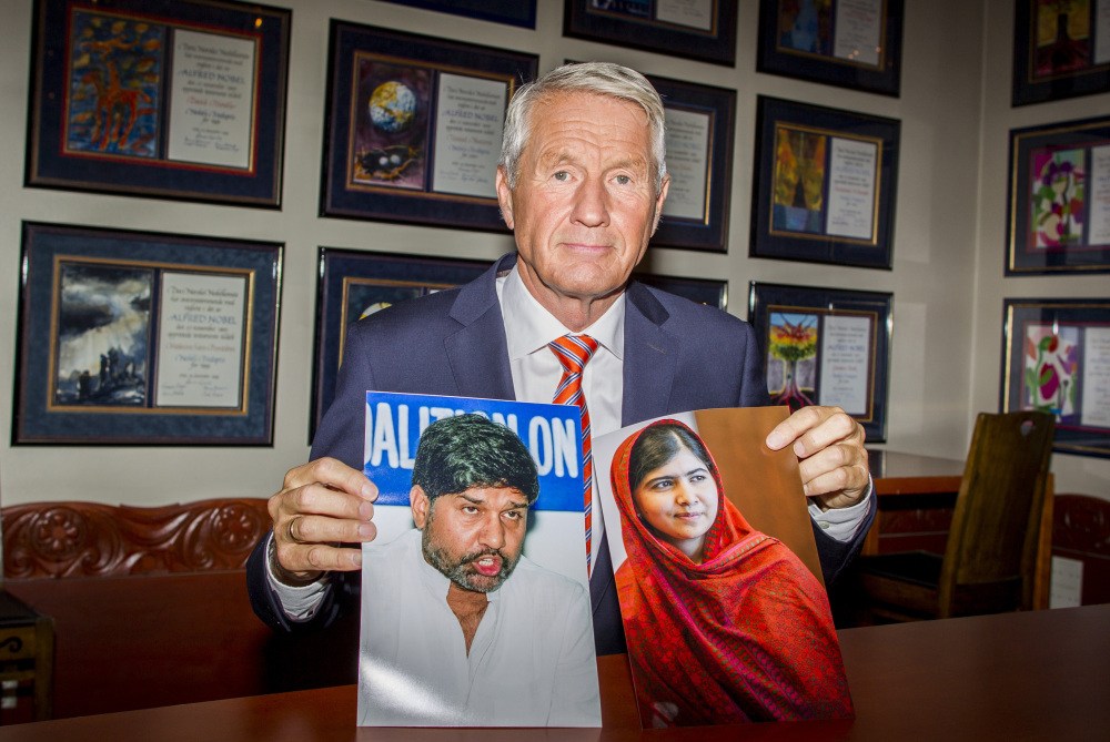 Chair of the Norwegian Nobel Committee, Thorbjorn Jagland holds photos of children’s rights activists Malala Yousafzai of Pakistan, right, and Kailash Satyarthi of India at The Norwegian Nobel Institute in Oslo on Friday, after they were awarded the Nobel Peace Prize 2014.