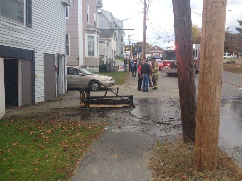 The remains of a couch are seen in a Spring Street driveway, after the flaming piece of furniture was extinguished and removed from the middle of the road.