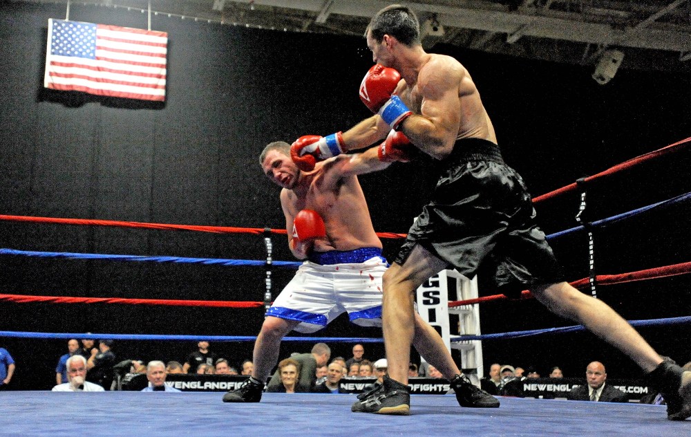 Joel “Baby Bull” Bishop, in white trunks, fights Jared “Last Minute” Lawton, in their pro debuts Saturday night at the Androscoggin Bank Colisee in Lewiston. The four-round fight ended in a draw.