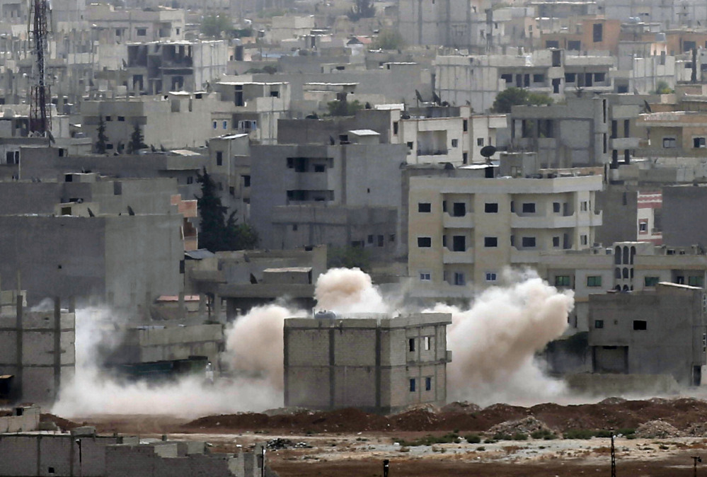 Smoke rises following a strike in Kobani, Syria while fighting continued between Syrian Kurds and the militants of Islamic State group, as seen from Mursitpinar on the outskirts of Suruc, at the Turkey-Syria border, Monday.