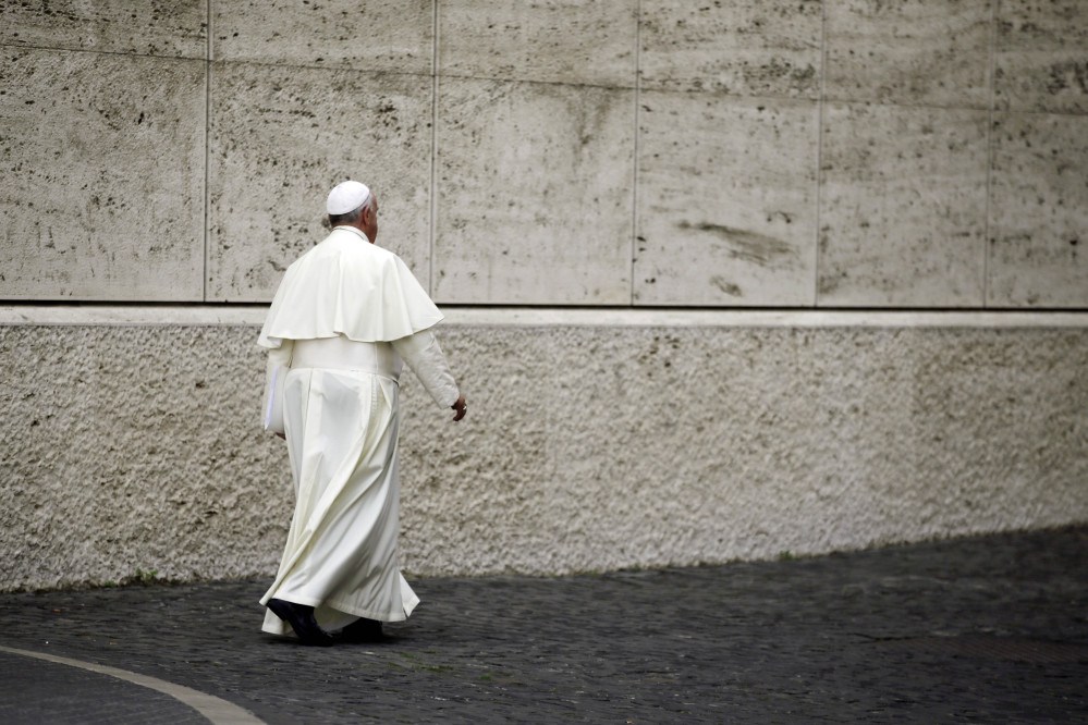 Pope Francis leaves at the end of a morning session of a two-week synod on family issues at the Vatican, Monday.