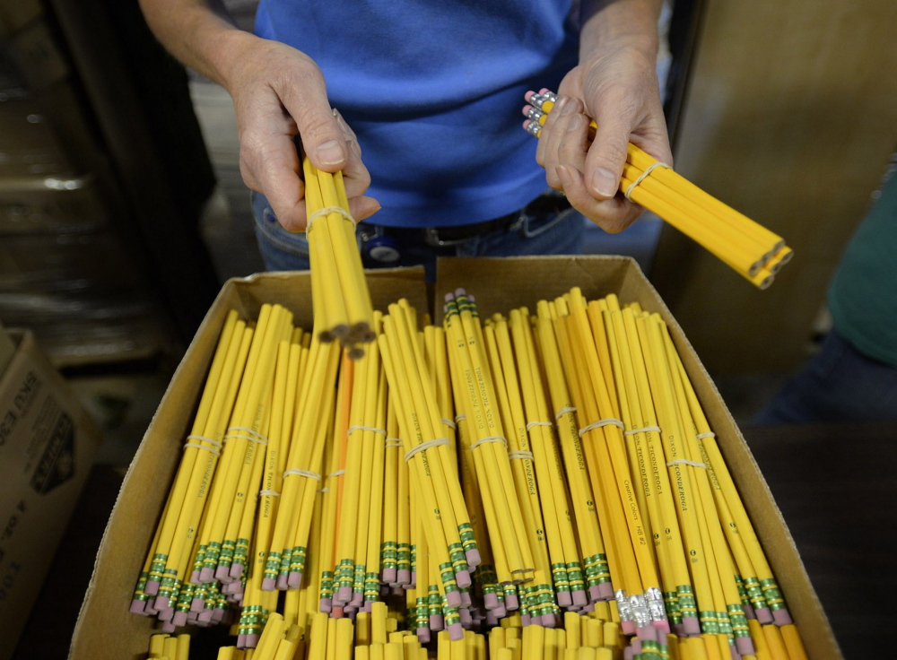 Lesley Reed, a volunteer from Unum, is prepared to hand out pencils to fill backpacks for needy students on Wednesday, Aug. 14, 2013.