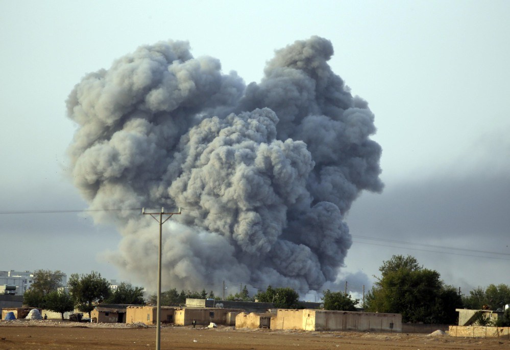 In this Monday, file photo, thick smoke rises following an airstrike by the US-led coalition in Kobani, Syria as fighting continued between Syrian Kurds and the militants of Islamic State group, as seen from Mursitpinar on the outskirts of Suruc, Turkey.
