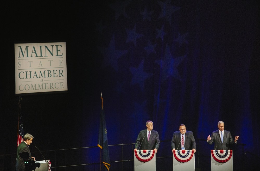 His rivals listen as Democrat Mike Michaud, right, answers a question about his voting record on women’s reproductive rights Wednesday during the gubernatorial debate. Pat Callaghan, far left, a longtime anchor with WCSH-6, served as moderator and worked diligently to keep the debate on track.