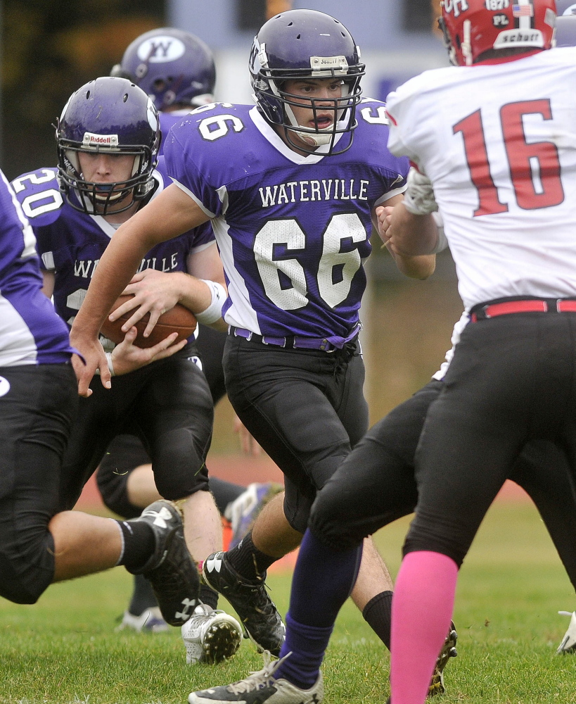 Waterville’s Alex Danner (66) looks to clear some room for running back Daniel Pooler during an Eastern C game against Camden Hillson Oct. 4.