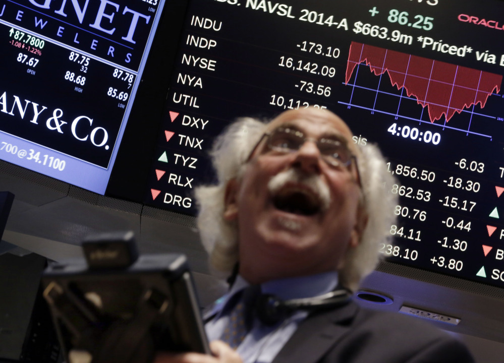 Trader Peter Tuchman watches a screen above the floor of the New York Stock Exchange at the closing bell Wednesday, as the Dow Jones industrial average plummeted as much as 460 points in afternoon trading, then clawed back much of the ground it lost. Europe’s economy is sputtering, oil prices are falling and stocks are swinging wildly. And Wall Street’s long dormant “fear index” predicts more turbulence ahead.