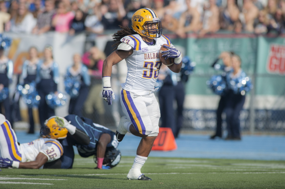 Albany lineman Christian Dorsey runs a recovered fumble 60 yards for a TD in the first half Saturday at Orono. Albany beat UMaine, 20-7.