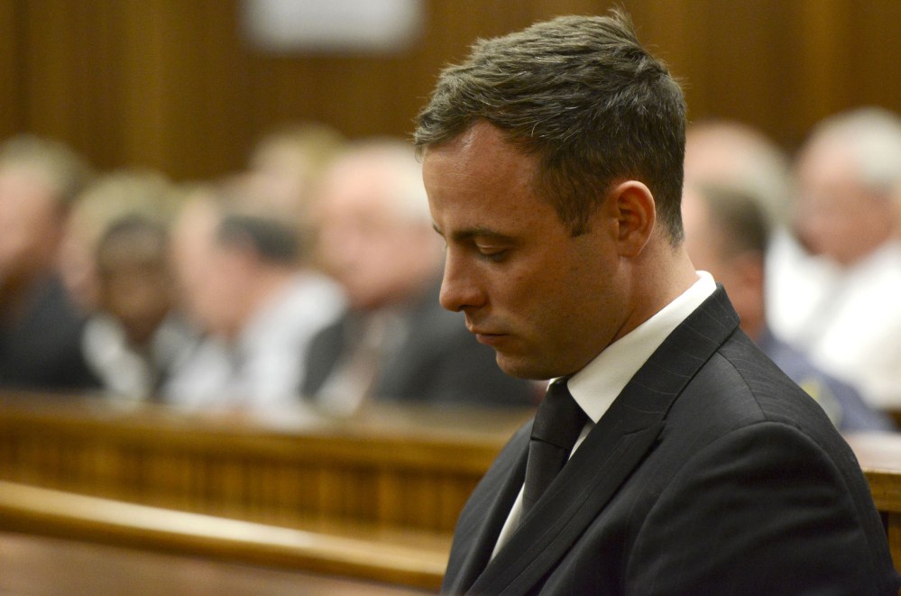 Oscar Pistorius sits in court in Pretoria, South Africa, on Tuesday after judge Thokozile Masipais sentenced him to five years in prison for culpable homicide in the killing of his girlfriend, Reeva Steenkamp, last year.