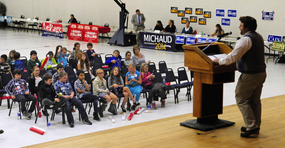 Students listen to a speech by Grady Burns from the Shenna Bellows for Senate campaign during the mock election rally-and-tally event Wednesday at the Augusta Armory.