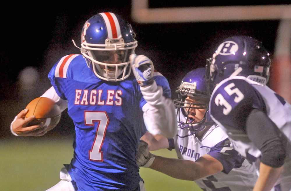 Messalonskee High School quarterback Jake Dexter (7) runs with the ball against Hampden Academy last week in Oakland. The Eagles are 4-3 this season despite low roster numbers and the death of student Cassidy Charette.