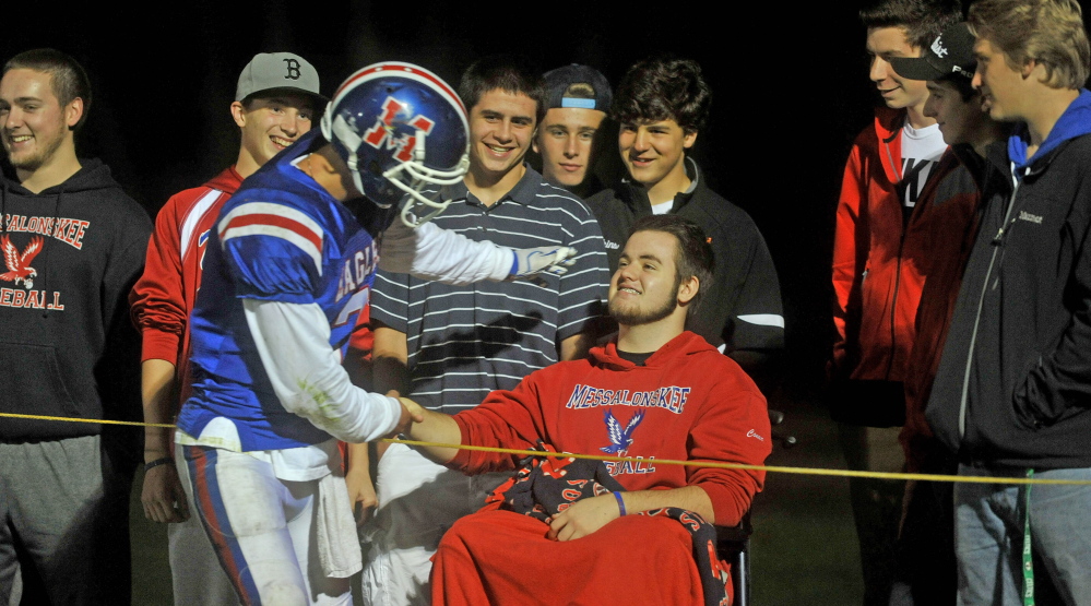 Messalonskee High School quarterback Jake Dexter greets Haunted Hayride victim Connor Garland after Dexter scored a touchdown in a 55-21 win over Hampden last Friday at Veterans Field in Oakland.