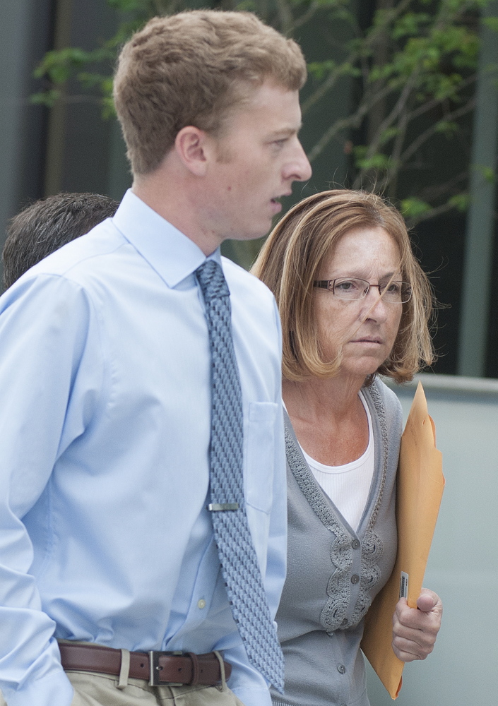 Carole Swan, former Chelsea selectwoman, with her son John Swan, enter the U.S. District Court building in Bangor on June 13 for her sentencing hearing on extortion, tax fraud and workers compensation fraud.