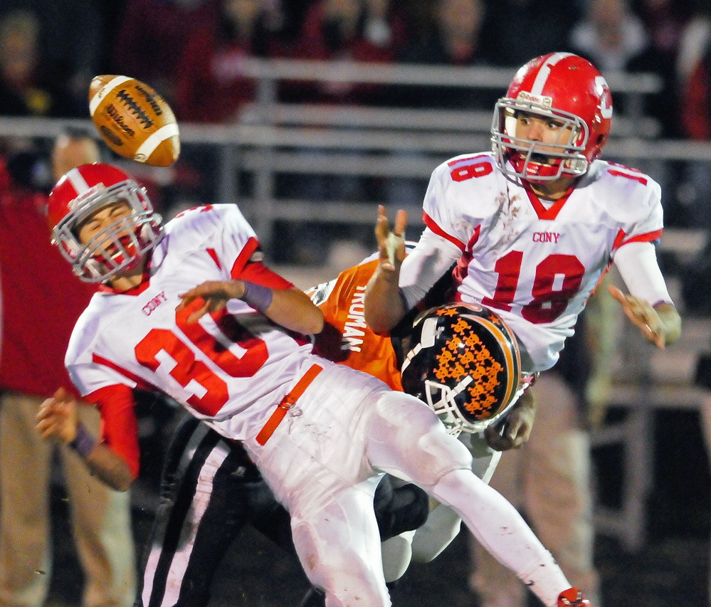 Staff file photo by Joe Phelan 
 Cony defensive backs Lucas Tyler, left, and Anthony Brunelle break up a pass intended for Gardiner tight end Jake Truman during a game last Friday night at Hoch Field. The Rams (6-2) earned the No. 2 seed in the PTC B playoffs and will await the winner of Lawrence-Brewer in the semifinals.