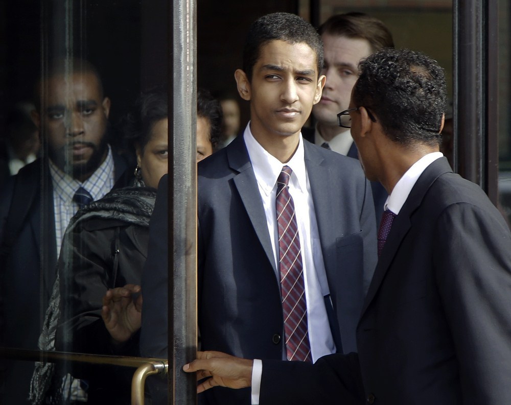 Robel Phillipos, center, departs federal court with defense attorney Derege Demissie, right, after he was convicted in Boston Tuesday on two counts of lying about being in the dorm room of Boston Marathon bombing suspect Dzhokhar Tsarnaev three days after the bombing in 2013, while two other friends removed a backpack containing fireworks and other potential evidence.