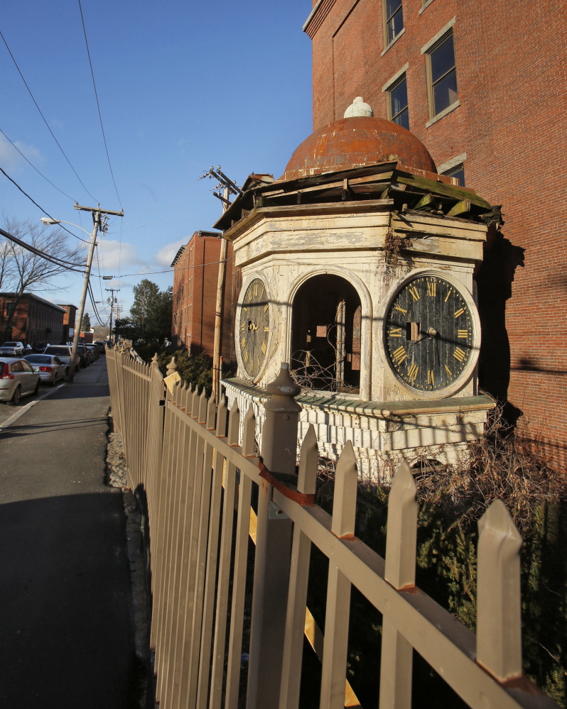 The clock and roof of the Lincoln Mill clock tower rest on the ground in Biddeford in January 2013. Maine Preservation has named the tower on its annual “Most Endangered Properties” list. Clock towers on mills were used to mark shift changes for workers.