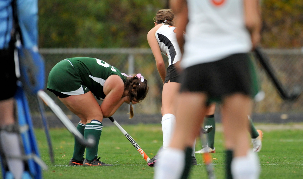 Mt. View High School’s Kate West, 16, holds her head after getting hit by a Winslow High School player during play in the second half at Winslow High School in their Eastern C semifinal game Tuesday.