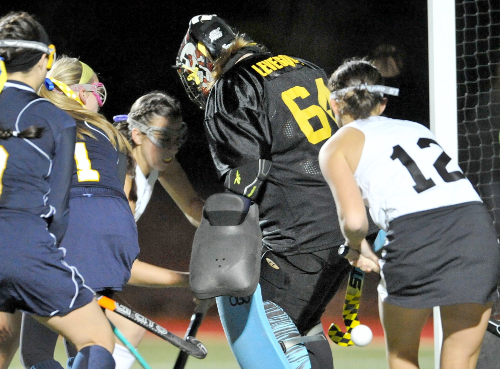 Skowhegan’s Brooke Michonski, back, left, scores on Mt. Blue Whitney Levesque as Skowhegan’s Cassidy Clement closes in on the play.