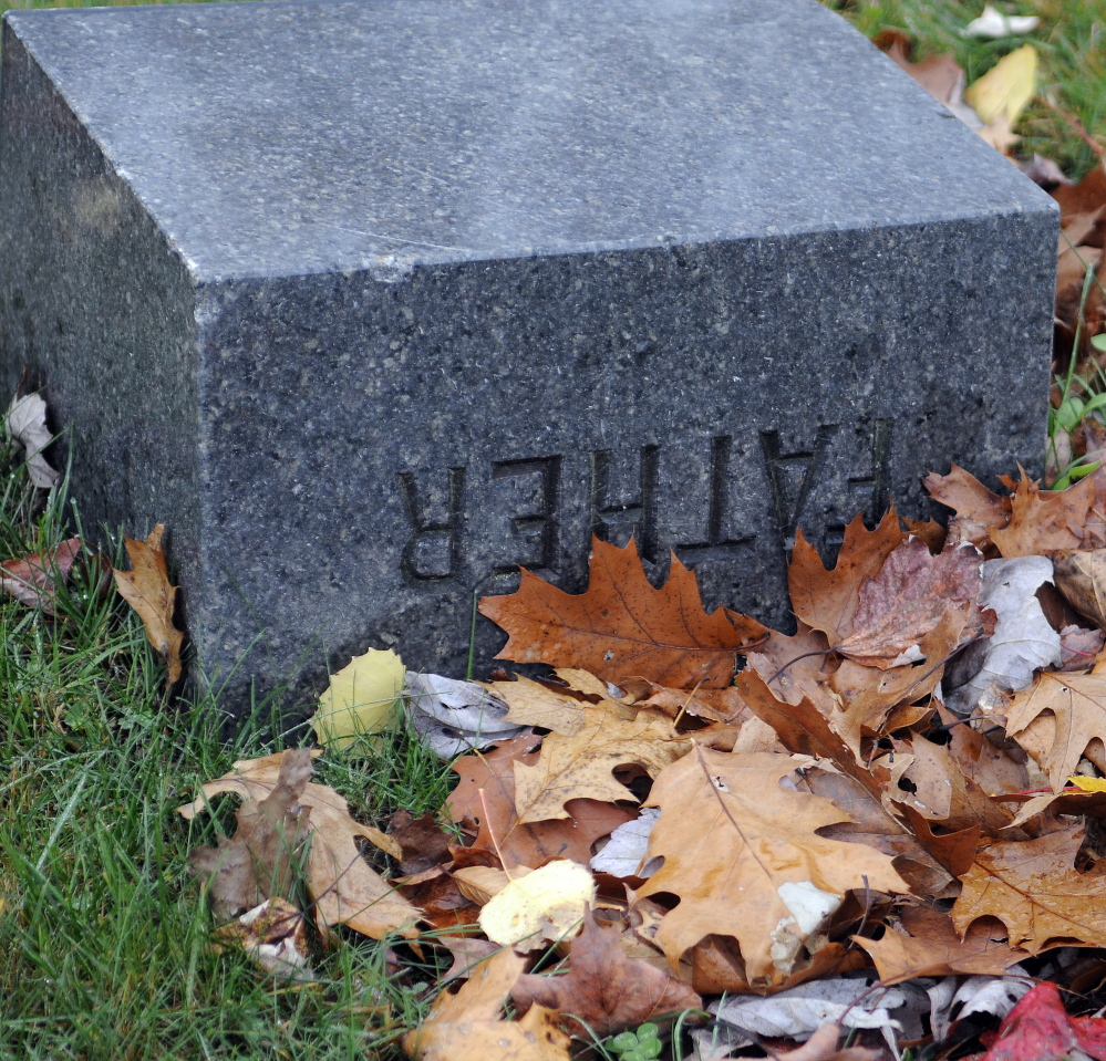 An overturned grave marker on Wednesday at the Monmouth Ridge Cemetery.