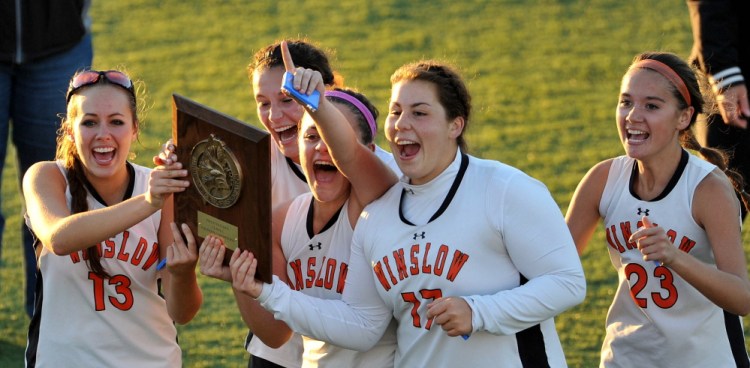 Winslow High School celebrates their Eastern Class C title over Dexter High School on Thursday at Hampden Academy. Winslow defeated Dexter 2-0.