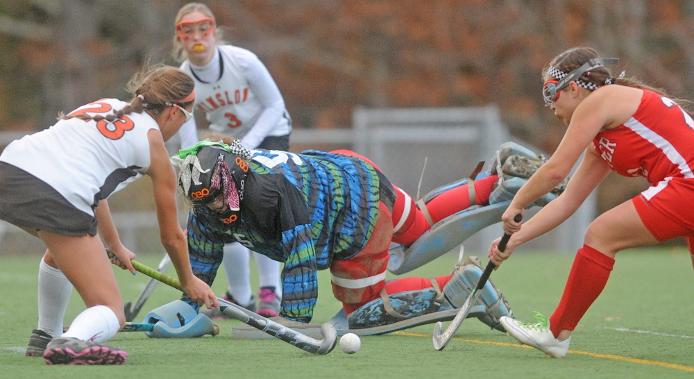 Dexter High School’s Cassidy Brown (22) defends Winslow High School’s Sarah Wildes (23) as she tries to score on Dexter High School goalie Kaitlyn Paquin (55) Thursday at Hampden Academy. Winslow defeated Dexter for the Eastern Class C title 2-0.