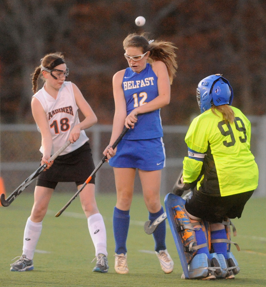 Gardiner Area High School’s Sarah Morgan, left, looks for the ball as it flies over Belfast’s Madison Pickering toward Belfast goalie Madison Littlefield in the first half of the Eastern Maine Class B regional final Thursday at Hampden Academy. Gardiner defeated Belfast for the Eastern Class B title 1-0 in overtime.