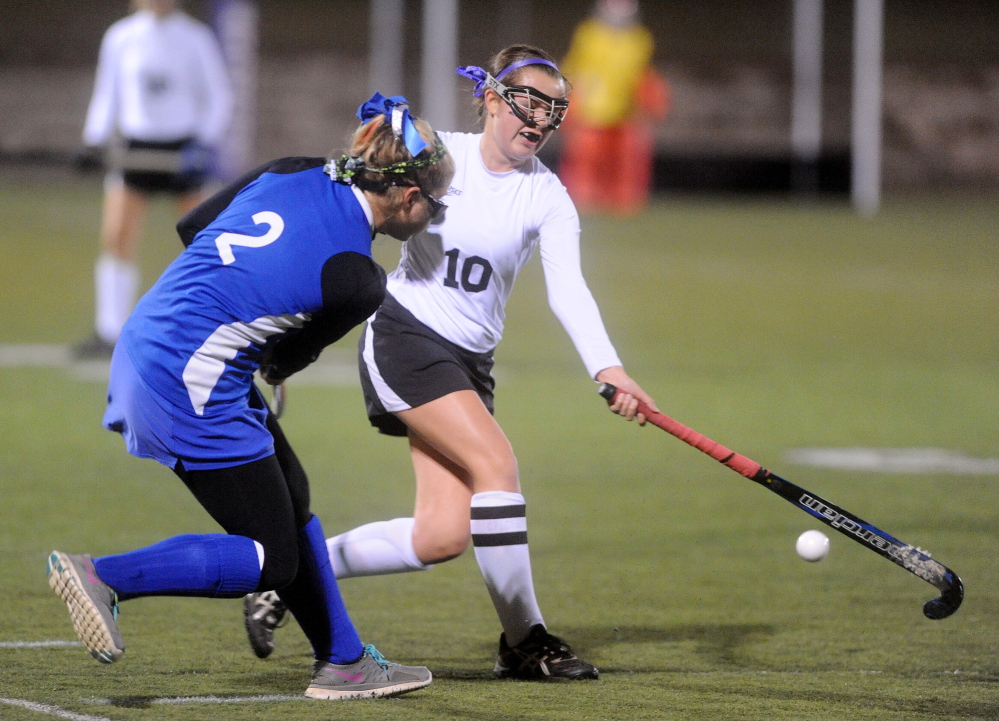 Skowhegan Area High School’s Victoria Mullin (1) defends Lawrence High School’s Dominique Lewis (2) in the first half in the Eastern Maine Class A title game Thursday at Hampden Academy. Skowhegan won 2-0.