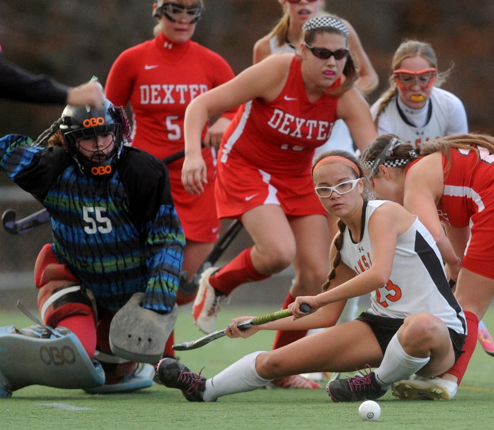 Winslow High School’s Sarah Wildes (23) goes down in front of the goal as Dexter High School goalie Kaitlyn Paquin (55) looks to defend during the Eastern Maine Class C regional final Thursday at Hampden Academy. Winslow defeated Dexter for the Eastern C title 2-0.