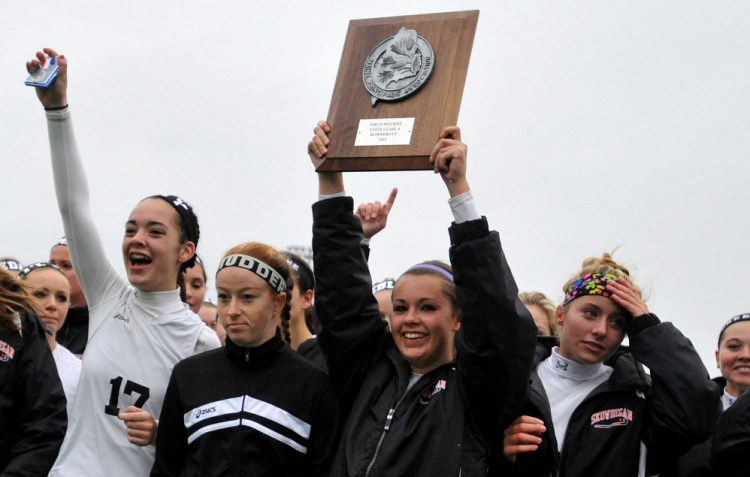 Members of the Skowhegan Area High School field hockey team show their Class A runner-up plaque after a 1-0 setback to Scarborough in the Class A state championship game Saturday at Thomas College.