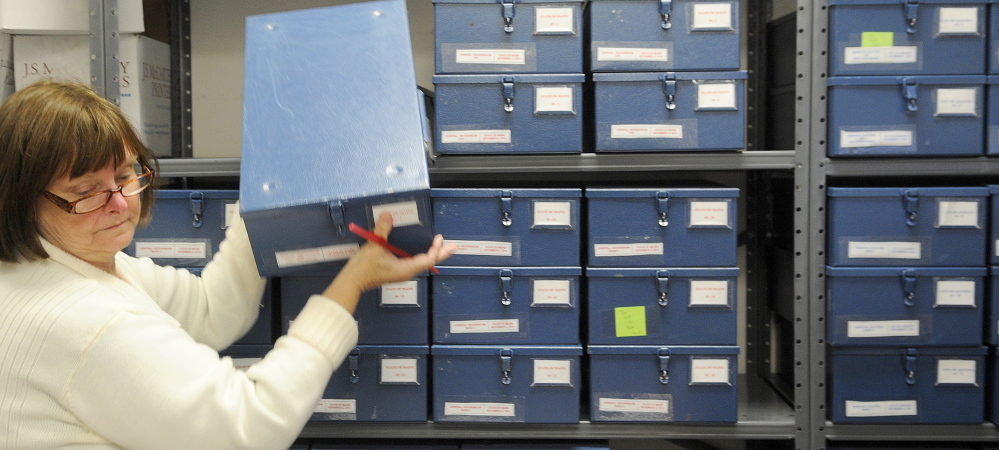 City of Augusta Clerk Barbara Wardwell collects a tamper-proof ballot box Monday at Augusta City Center. Ballots are secured in the lock boxes after votes are cast.