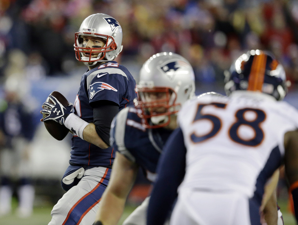 New England Patriots quarterback Tom Brady, looks for a receiver against the rush by Denver Broncos outside linebacker Von Miller (58) in the first half Sunday in Foxborough, Mass. The Patriots beat the Broncos 43-21.