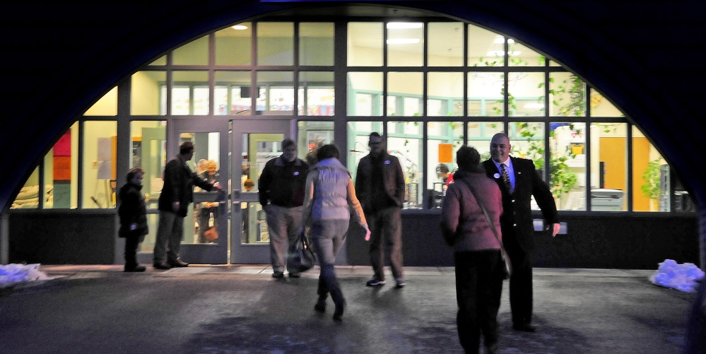 Curtis Ayotte, a Republican candidate for state representative in House District 83, left, greets voters around 5:40 p.m. on Tuesday at the Boys and Girls Club of Greater Gardiner.