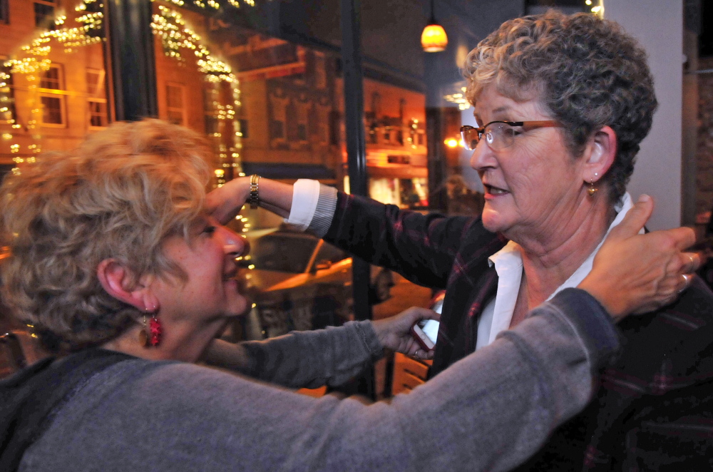 Birdie Newman Katz, left, hugs Donna Doore on Tuesday at Charlamagne’s in Augusta. Doore, a Democrat, won the House District 85 race, and Katz’s husband, incumbent Republican Sen. Roger Katz, won the Senate District 15 race.