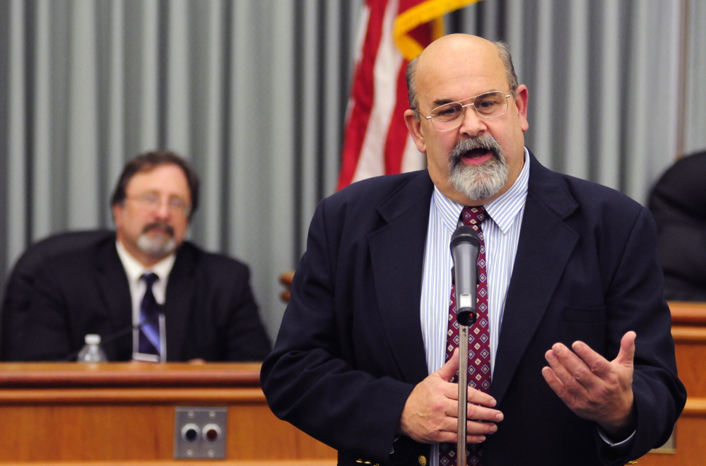 Outgoing Mayor Marc O’Brien, left, listens Thursday evening as newly elected Augusta Mayor Dave Rollins speaks after being sworn in at the start of a City Council meeting at Augusta City Center.