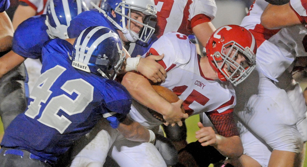 Cony quarterback Mitchell Caron, right, drives through the line during a Pine Tree Conference Class B game against Lawrence in Fairfield this season. The two teams meet again Saturday, this time at Alumni Field, and with a trip to the conference title game at stake.